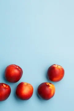 A few ripe nectarines on a blue background Stock Photos