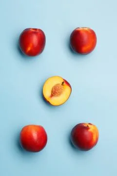 A few ripe nectarines on a blue background Фото