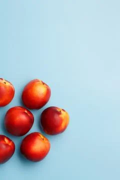 A few ripe nectarines on a blue background Фото