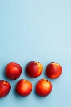 A few ripe nectarines on a blue background Stock Photos