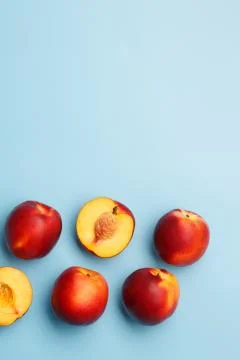 A few ripe nectarines on a blue background Stock Photos