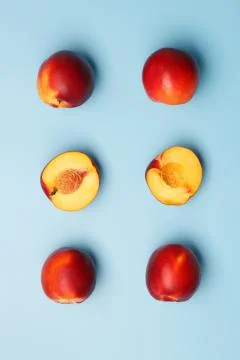 A few ripe nectarines on a blue background Stock Photos