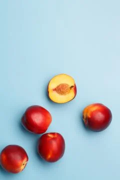 A few ripe nectarines on a blue background Stock Photos