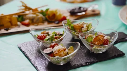 A few servings of salad. Red cherry tomatoes, crackers, green salad and Parmesan Stock-Footage 140439381