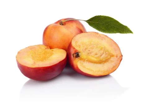 Few sliced nectarines with leaf isolated on white background Stock Photos