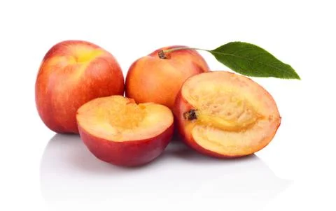Few sliced nectarines with leaf isolated on white background Stock Photos