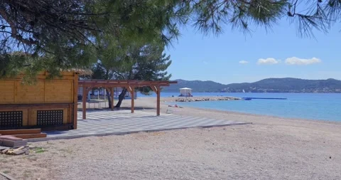 Few tourists on an empty beach. Video stock 132729840