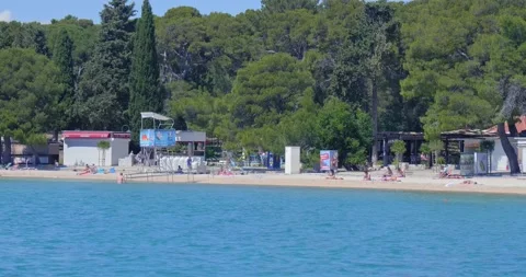 Few tourists on an empty beach. Stock Footage 132730114