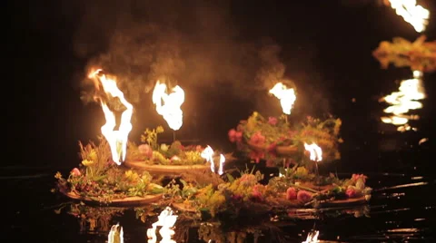 Few wreaths with torches float down the river Stock Footage 47071174