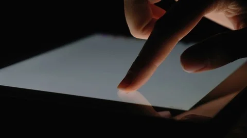 Ffinger writes on a tablet the number 2018 in the dark, close-up, 4k. Video stock 84637980