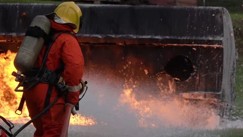 FHD Slow motion: Firefighter using Chemical foam fire extinguisher to fightin Stock Footage 146883306