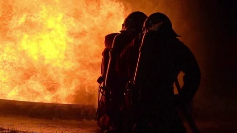 FHD Slow motion Firefighters using Twirl water fog type fire extinguisher to  Stock Footage 146883952