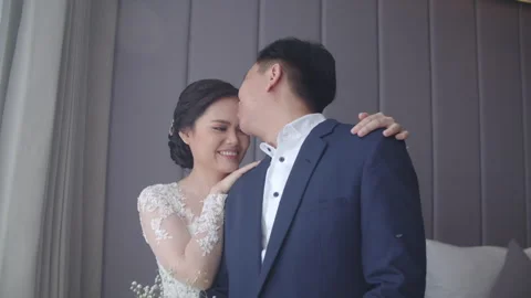 Fiancee Embracing Her Partner with a Sweet Forehead Kiss Stock Footage 334026361