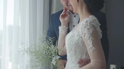 Fiancee Touching Groom In Front of Bright Indoor Window In Hotel Stock Footage 334026166