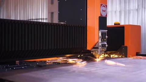 Fiber laser cutting CNC machine making holes in metal list sheet. Workshop Stock Footage 143334044