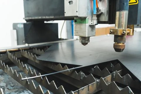 The fiber laser cutting machine cutting machine cut the metal plate. The hi Stock Photos