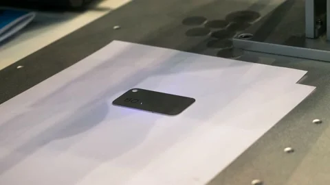 Fiber laser engraving machine marking metal smartphone panel at the exhibition Stock Footage 158822131