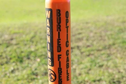 Fiber optic buried cable warning post Stock Photos