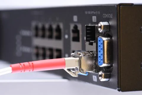 Fiber optic cable connected to switch Stock Photos