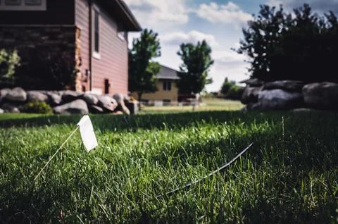Fiber optic cable laying in the grass ready to be installed at a residential Stock Photos