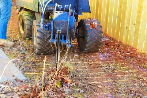 Fiber optic cables are laid with assistance of a trencher cable plow tractor Stock Photos