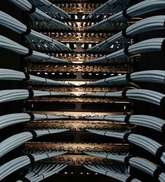 Fiber Optic Cables Connected to Network Equipment in Data Center Stock Photos