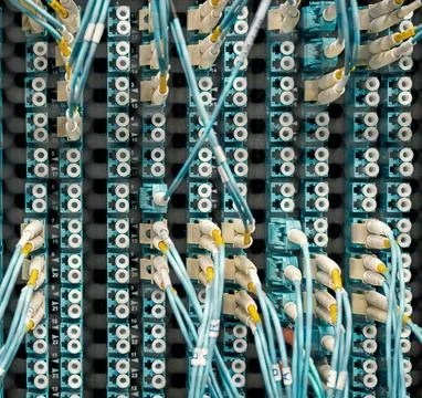 Fiber Optic Cables Connected to Network Equipment in Data Center Stock Photos