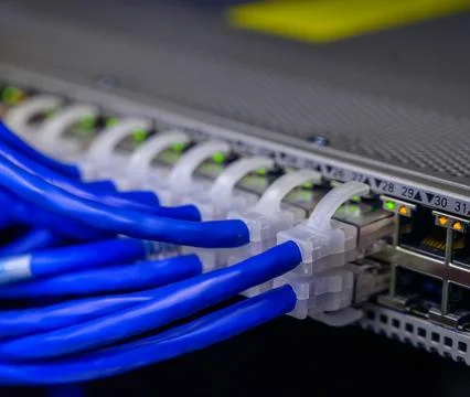 Fiber Optic Cables Connected to Network Equipment in Data Center Stock Photos