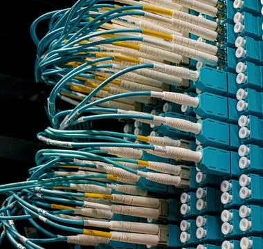 Fiber Optic Cables Connected to Network Equipment in Data Center Stock Photos