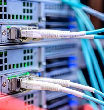 Fiber Optic Cables Connected to Network Equipment in Data Center Stock Photos