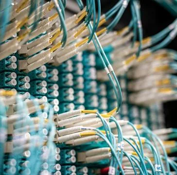 Fiber Optic Cables Connected to Network Equipment in Data Center Stock Photos
