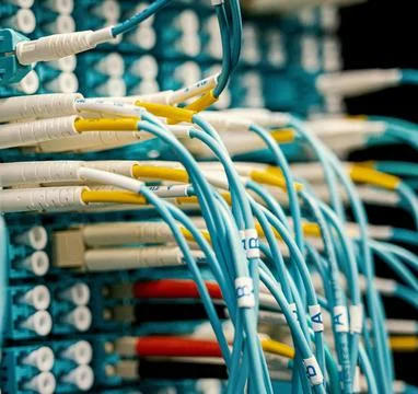 Fiber Optic Cables Connected to Network Equipment in Data Center Stock Photos