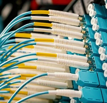 Fiber Optic Cables Connected to Network Equipment in Data Center Stock Photos