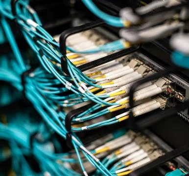 Fiber Optic Cables Connected to Network Equipment in Data Center 스톡 사진