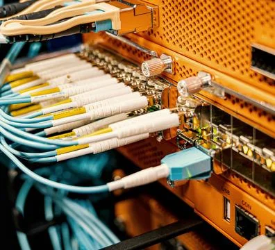 Fiber Optic Cables Connected to Network Equipment in Data Center Stock Photos