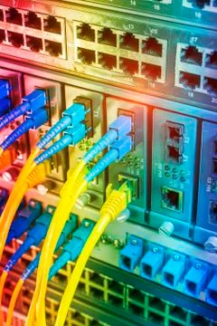 Fiber Optic cables connected to an optic ports and Network cables connected t Stock Photos