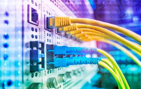 Fiber Optic cables connected to an optic ports and Network cables connected t Stock Photos