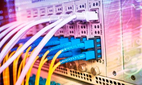 Fiber Optic cables connected to an optic ports and Network cables connected t Stock Photos