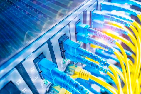 Fiber Optic cables connected to optic ports and UTP, Network cables connected Stock Photos