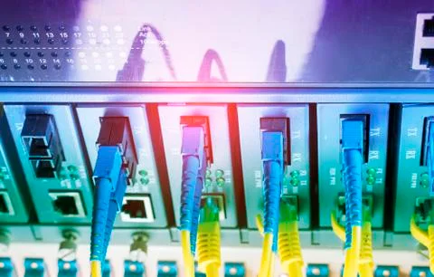 Fiber Optic cables connected to optic ports and UTP, Network cables connected Stock Photos