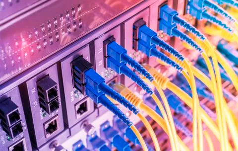 Fiber Optic cables connected to optic ports and UTP, Network cables connected Stock Photos