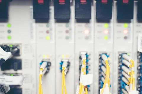 Fiber Optic cables connected to an optic ports and Network cable system Stock Photos