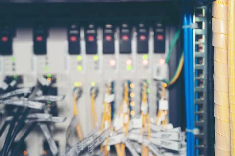 Fiber Optic cables connected to an optic ports and Network cable system Stock Photos