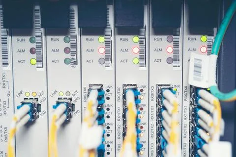 Fiber Optic cables connected to an optic ports and Network cable system Stock Photos