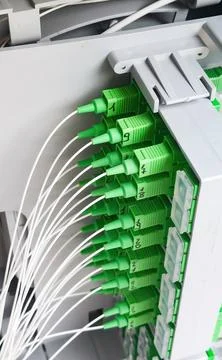 Fiber optic cables connecting to a server in a data center Stock Photos