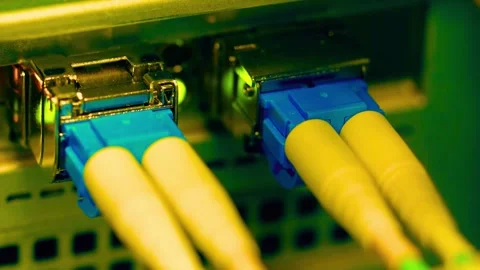 Fiber optic cables plugged into network switch with blinking lights. Stock Footage 339629117