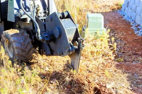 Fiber optic cables were laid with assistance of a trencher cable plow tractor Stock Photos