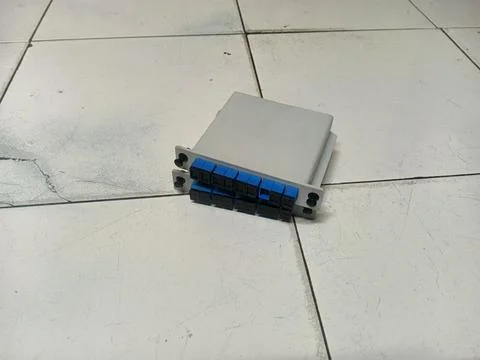 Fiber optic cassette module on a tiled floor Stock Photos