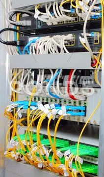 Fiber optic datacenter with media converters and optical cables Stock Photos