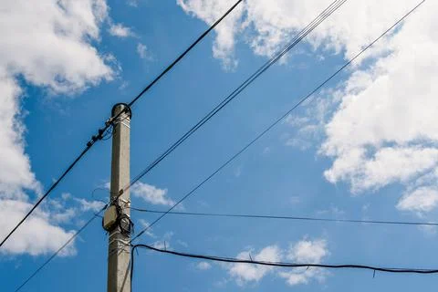Fiber optic distribution box and electrical wires on a pole Stock Photos